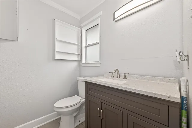 a bathroom with a sink toilet and a mirror