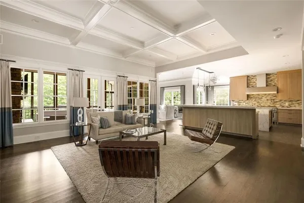 a large bedroom with a large bed a couch and a fireplace