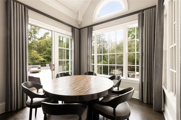a large bed sitting in a bedroom next to a window and a chandelier