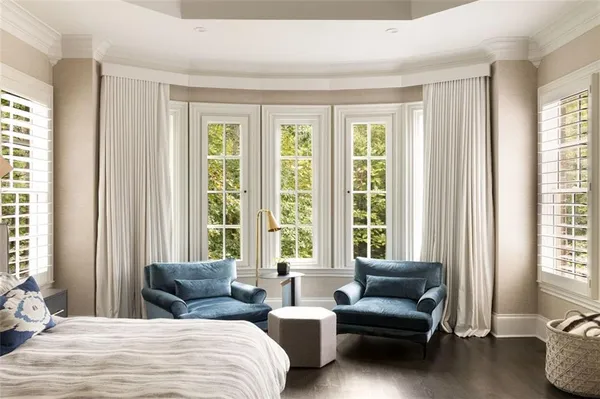 a table and chairs in a room next to a window