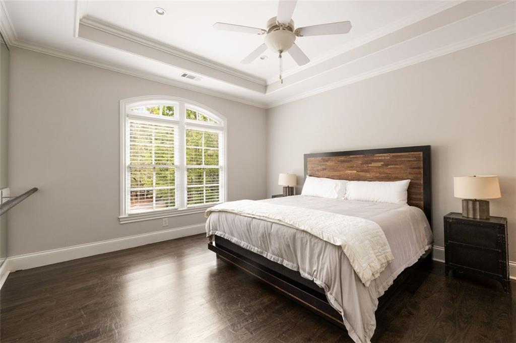 11015 Stroup Road Roswell, GA 30075 - Photo 48 of 113 a large bed sitting in a bedroom next to a window and a chandelier