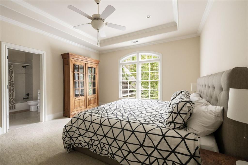 11015 Stroup Road Roswell, GA 30075 - Photo 51 of 113 a bedroom with a bed and glass walk in closet