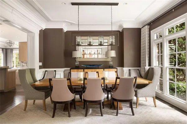 a living room with furniture a fireplace and a large window