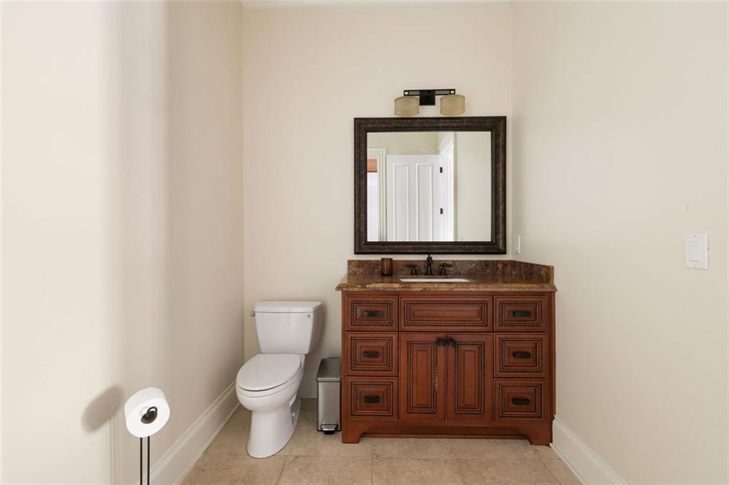 11015 Stroup Road Roswell, GA 30075 - Photo 70 of 113 a bathroom with a toilet a sink and mirror