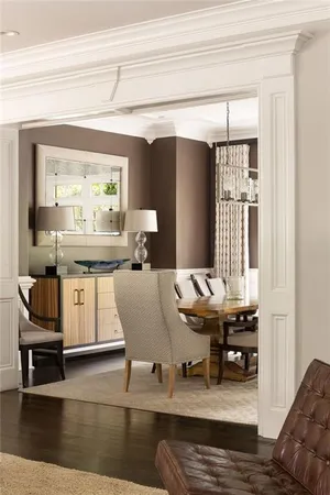 a living room with furniture large window and wooden floor