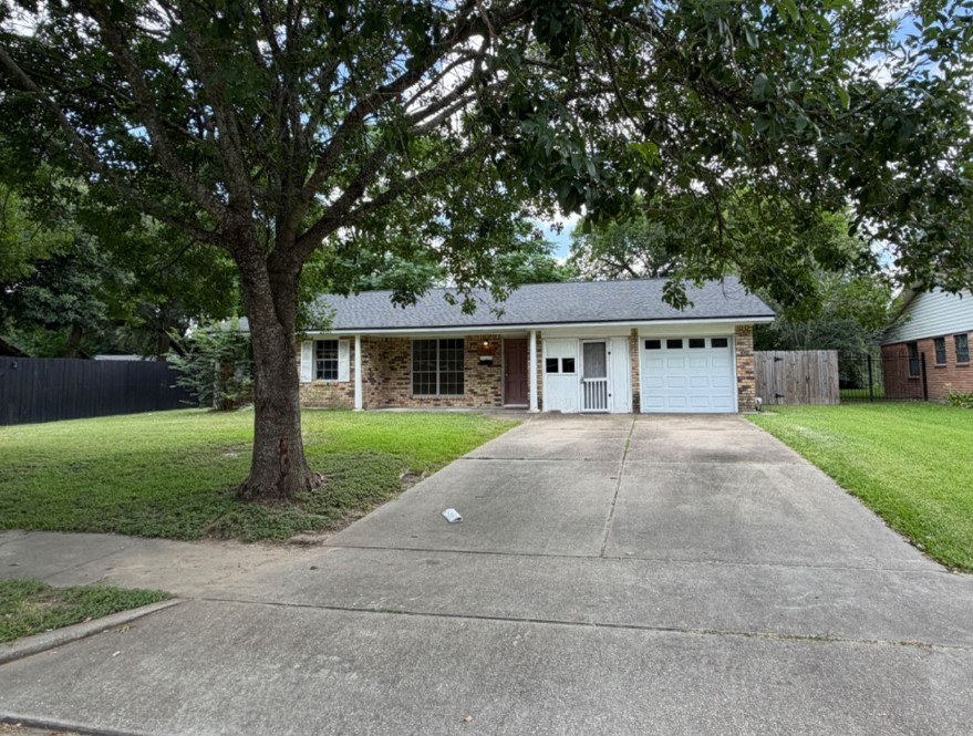 7314 Cannock Road Houston, TX 77074 - Photo 2 of 6 a front view of house with yard and green space