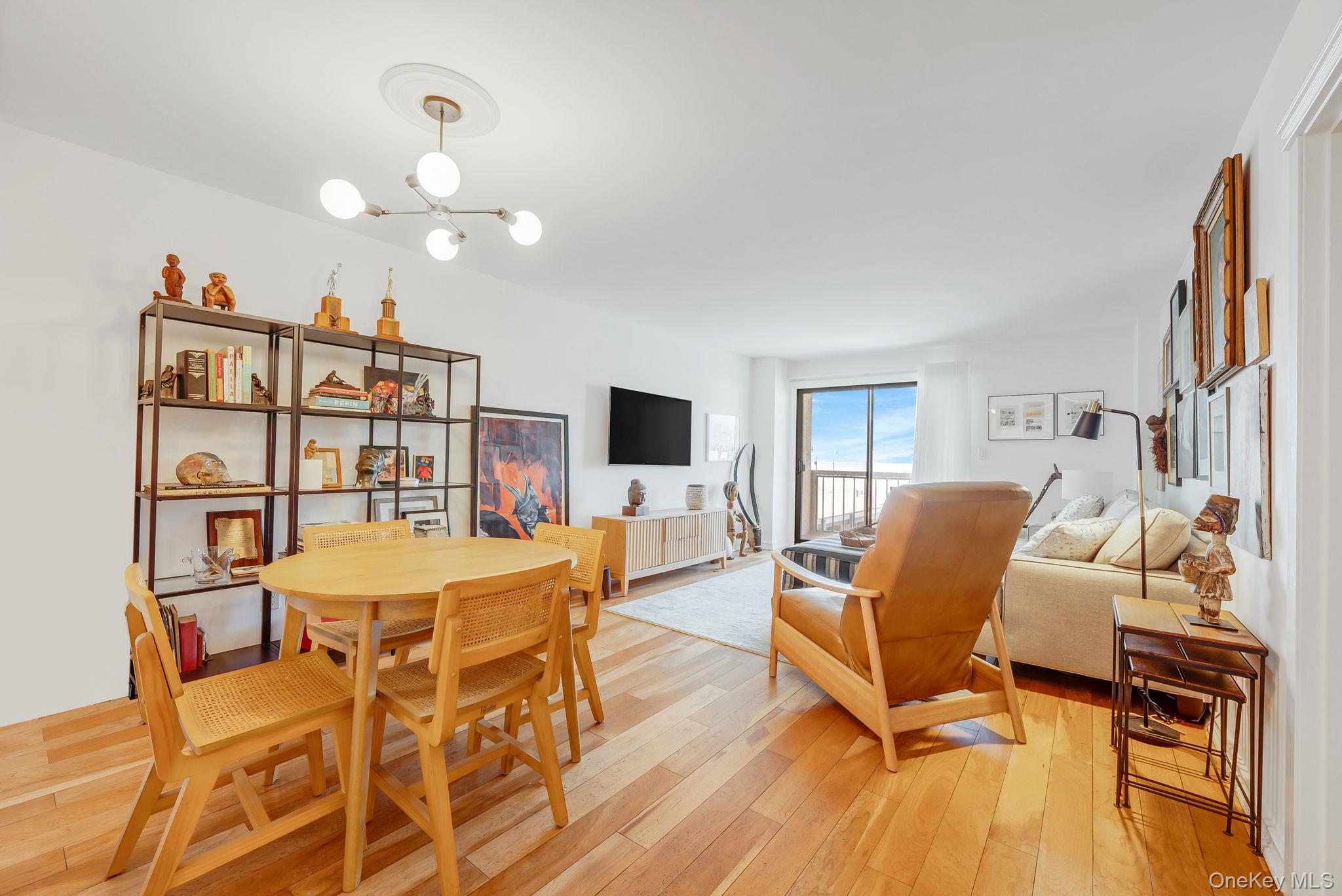 360 Shore Road, Unit 3H Long Beach, NY 11561 - Photo 10 of 23 a living room with furniture and a flat screen tv