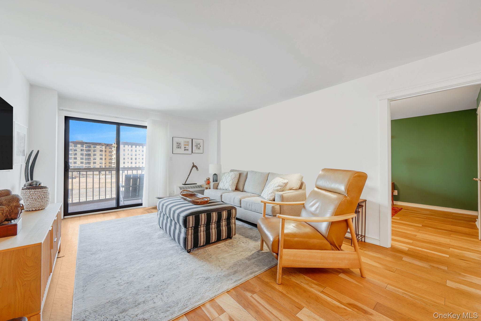 360 Shore Road, Unit 3H Long Beach, NY 11561 - Photo 12 of 23 a living room with furniture and a flat screen tv
