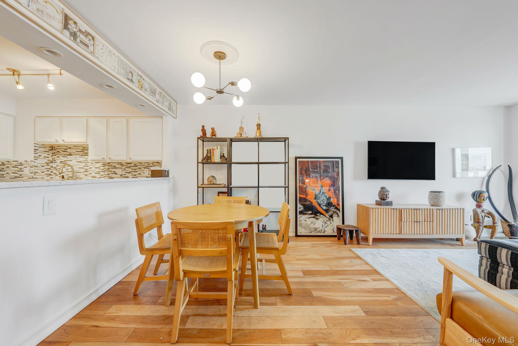 360 Shore Road, Unit 3H Long Beach, NY 11561 - Photo 13 of 23 a view of a dining room with furniture and wooden floor