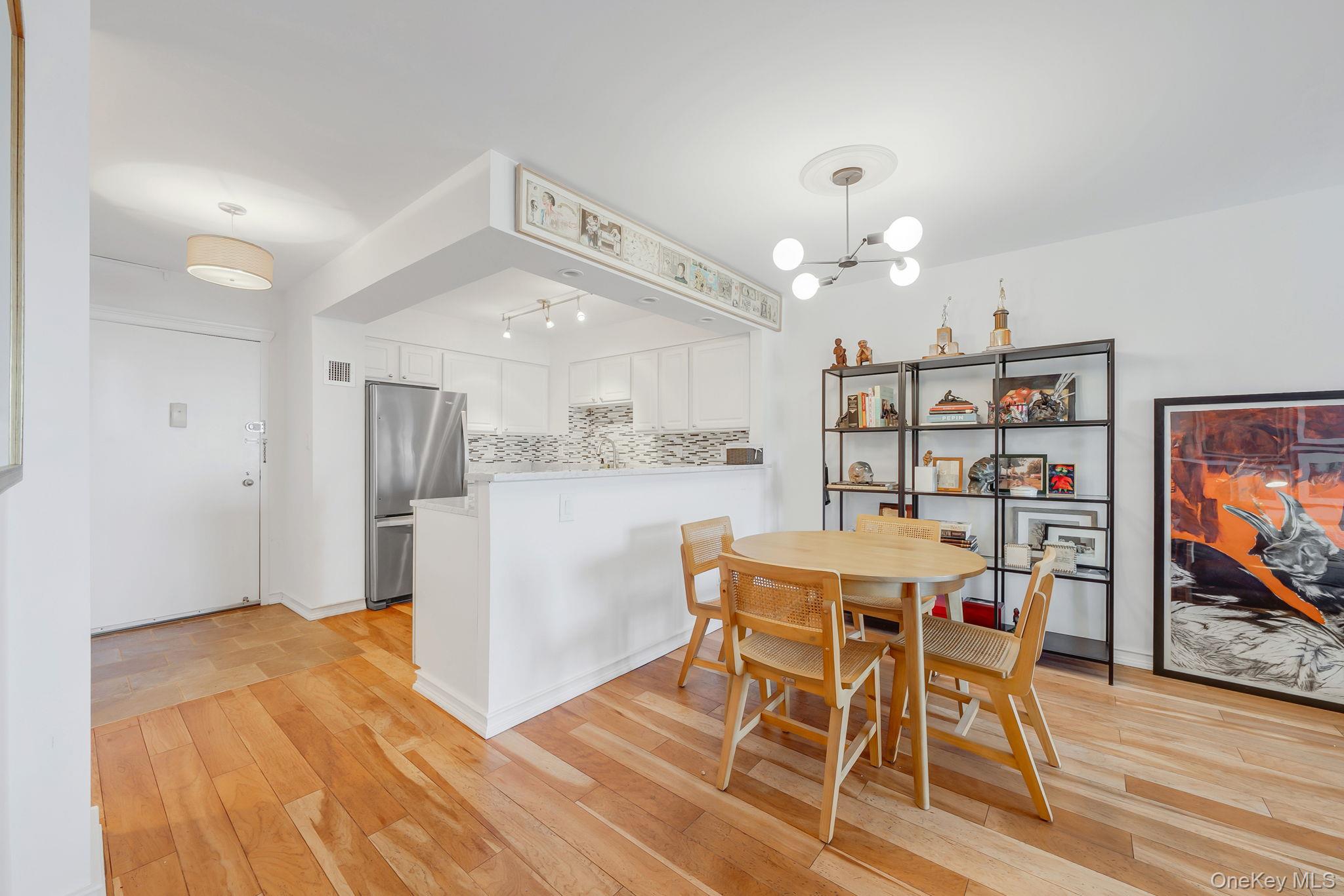 360 Shore Road, Unit 3H Long Beach, NY 11561 - Photo 14 of 23 a view of a dining room with furniture and wooden floor