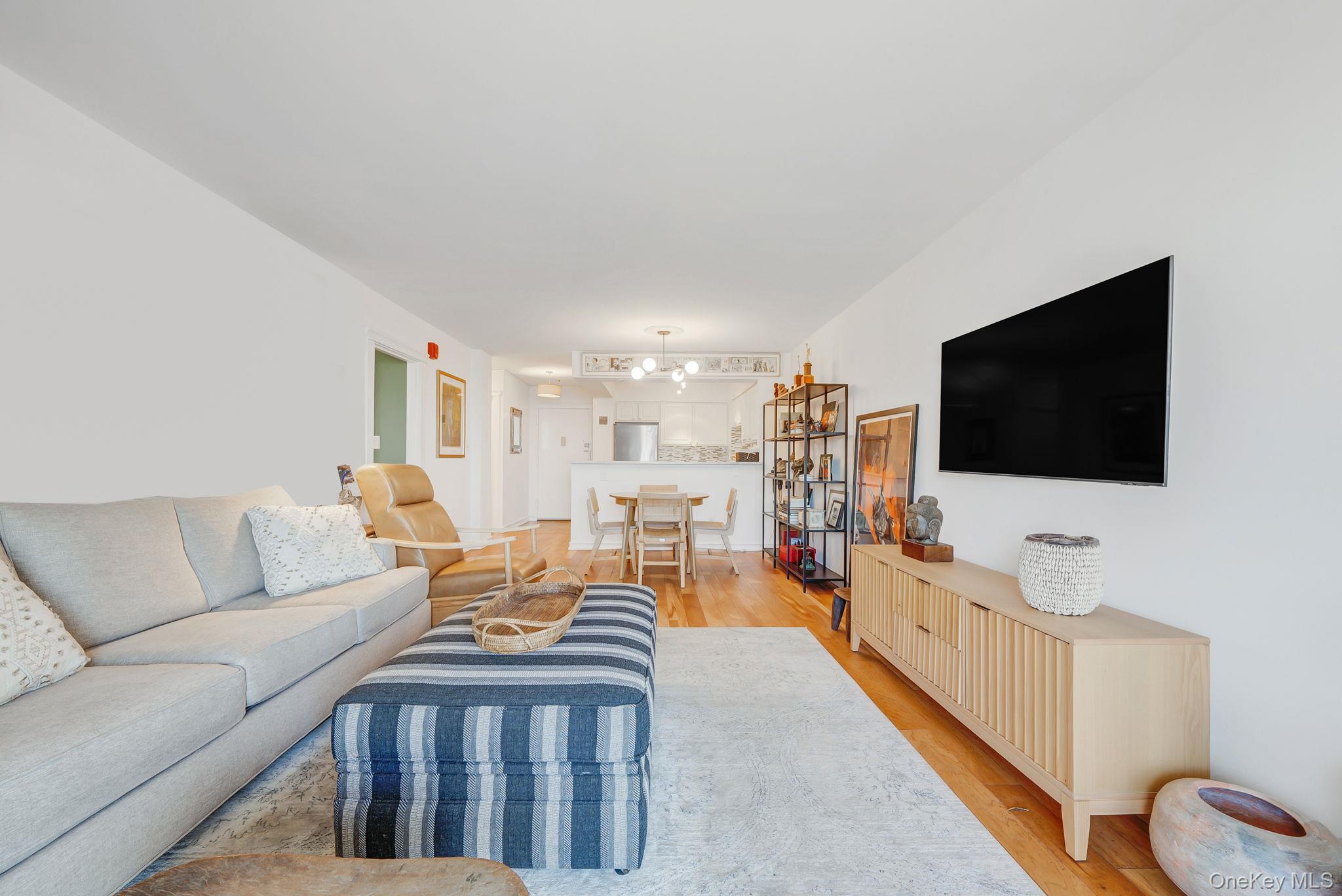 360 Shore Road, Unit 3H Long Beach, NY 11561 - Photo 15 of 23 a living room with furniture and a flat screen tv