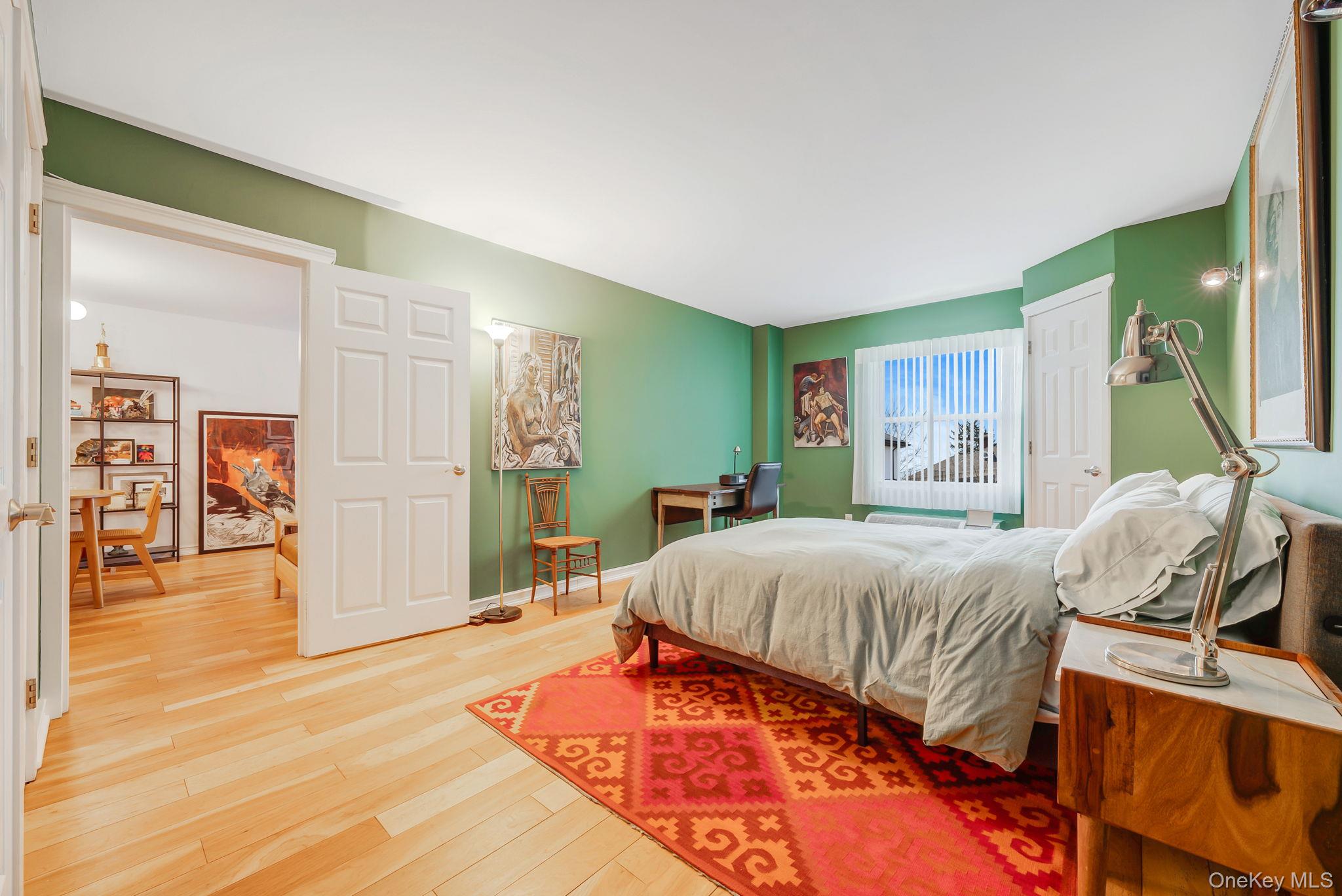 360 Shore Road, Unit 3H Long Beach, NY 11561 - Photo 18 of 23 a bed room with a bed and a mirror