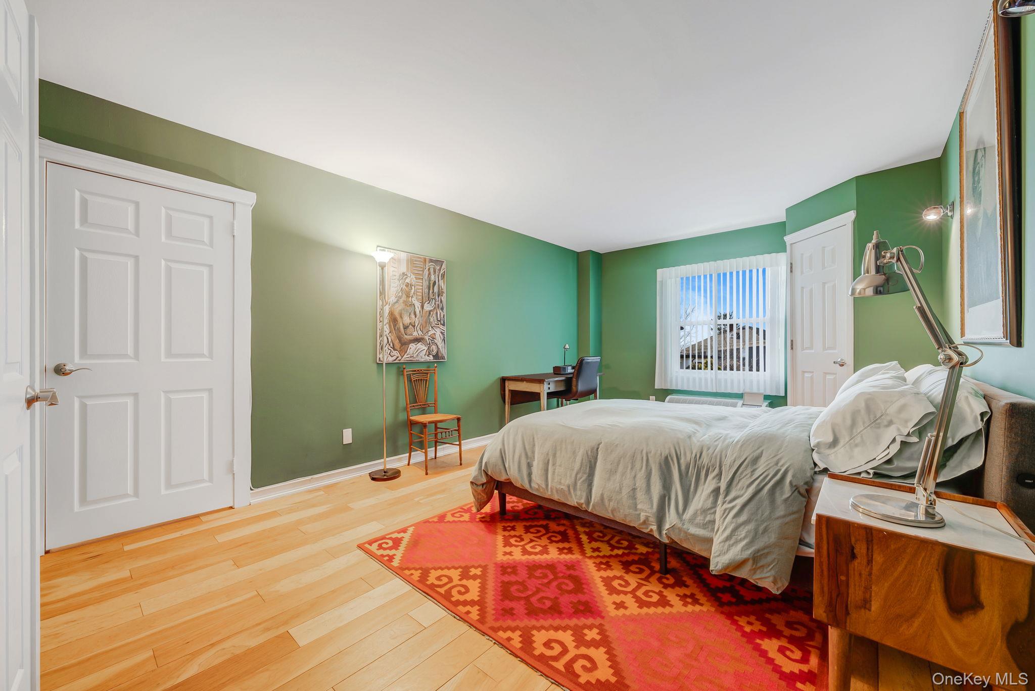 360 Shore Road, Unit 3H Long Beach, NY 11561 - Photo 19 of 23 a bedroom with a large bed and a window