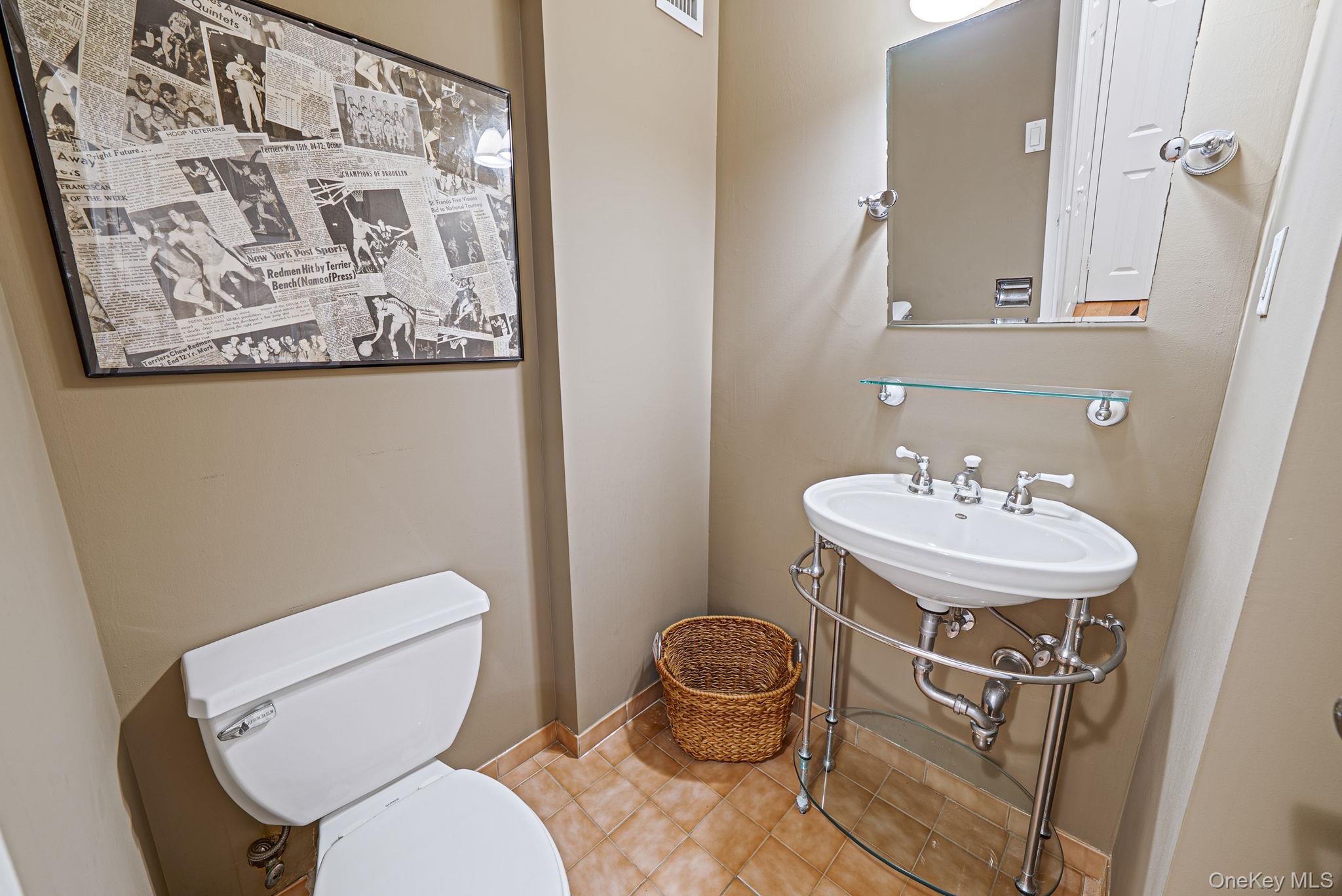 360 Shore Road, Unit 3H Long Beach, NY 11561 - Photo 21 of 23 a bathroom with a toilet a sink and a mirror