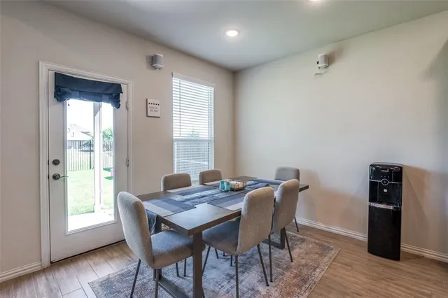 a view of a dining room with furniture and wooden floor