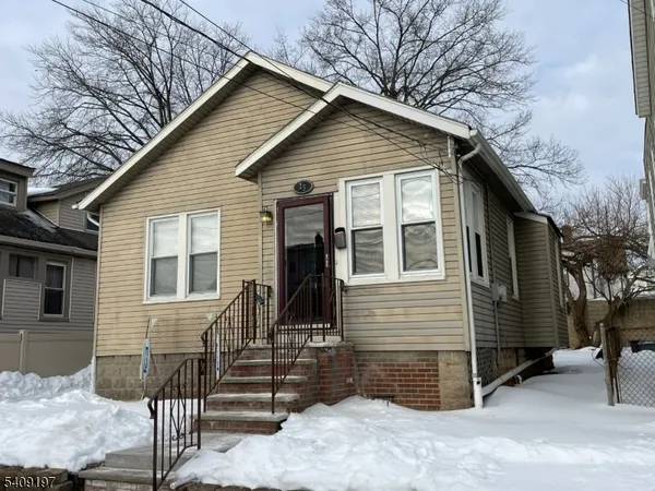 a view of a house with a yard and garage