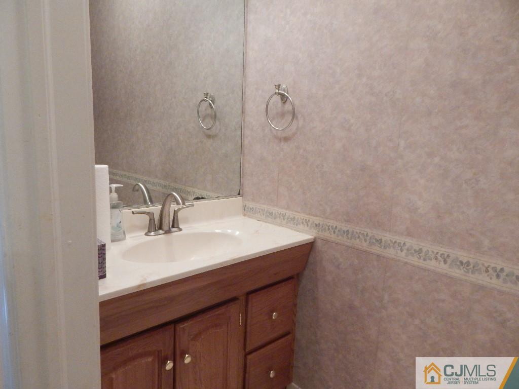 203 Timber Oaks Road Edison, NJ 08820 - Photo 8 of 16 a bathroom with a sink and a mirror