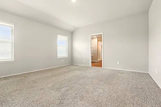 an empty room with windows and closet