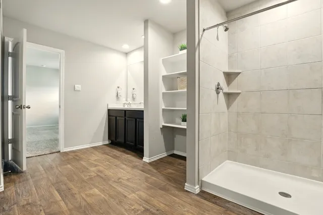a bathroom with a glass shower door