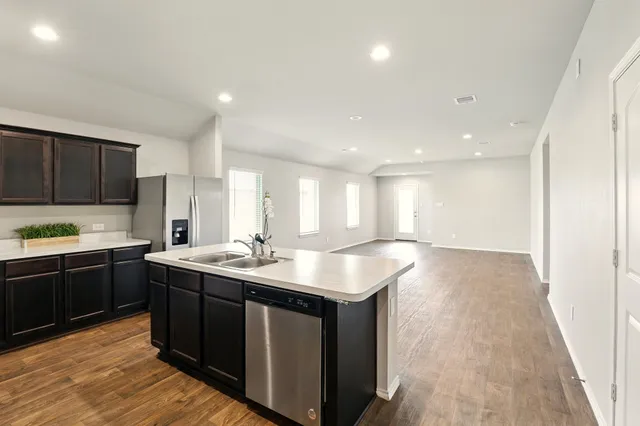 a kitchen with stainless steel appliances granite countertop a sink stove and cabinets