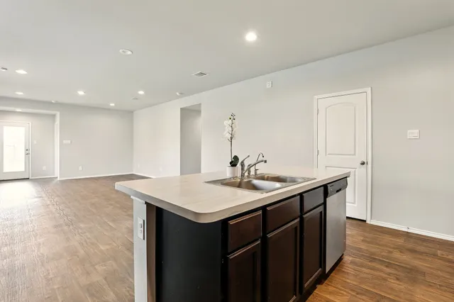 a kitchen with a sink and a mirror