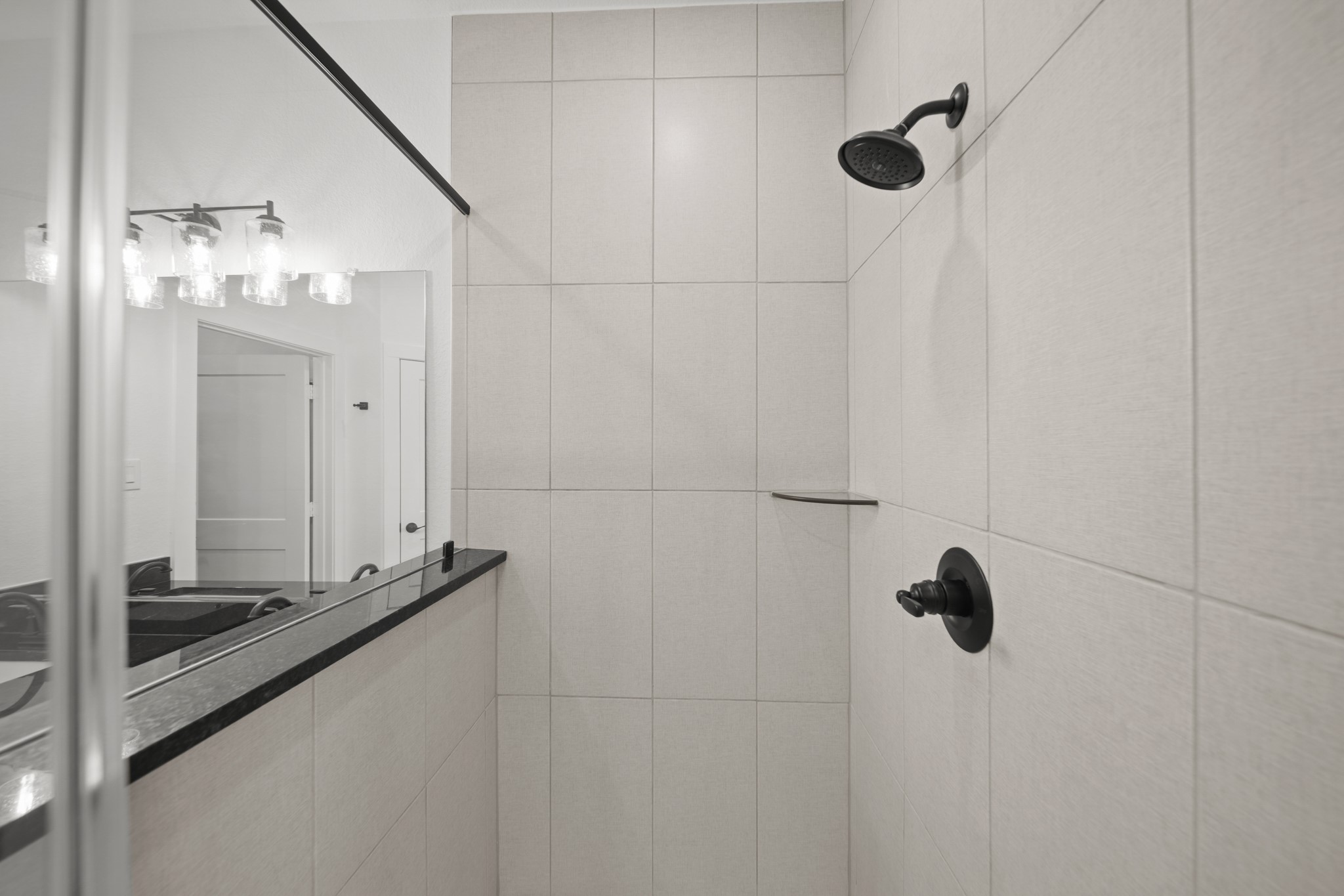 10111 Crescendo Way Manvel, TX 77578 - Photo 15 of 25 a bathroom with a shower and a mirror