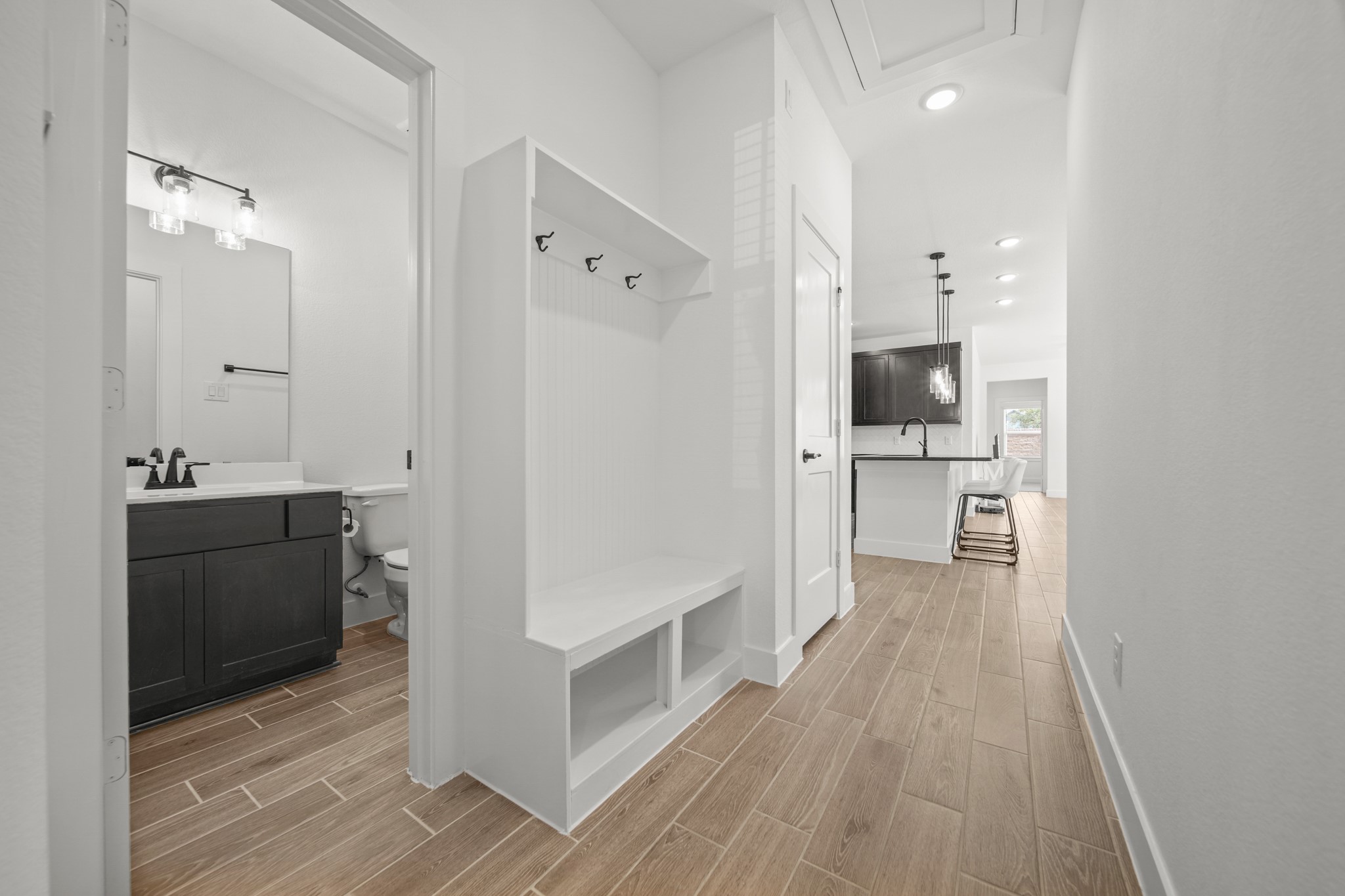 10111 Crescendo Way Manvel, TX 77578 - Photo 20 of 25 a view of hallway with sink and wooden floor