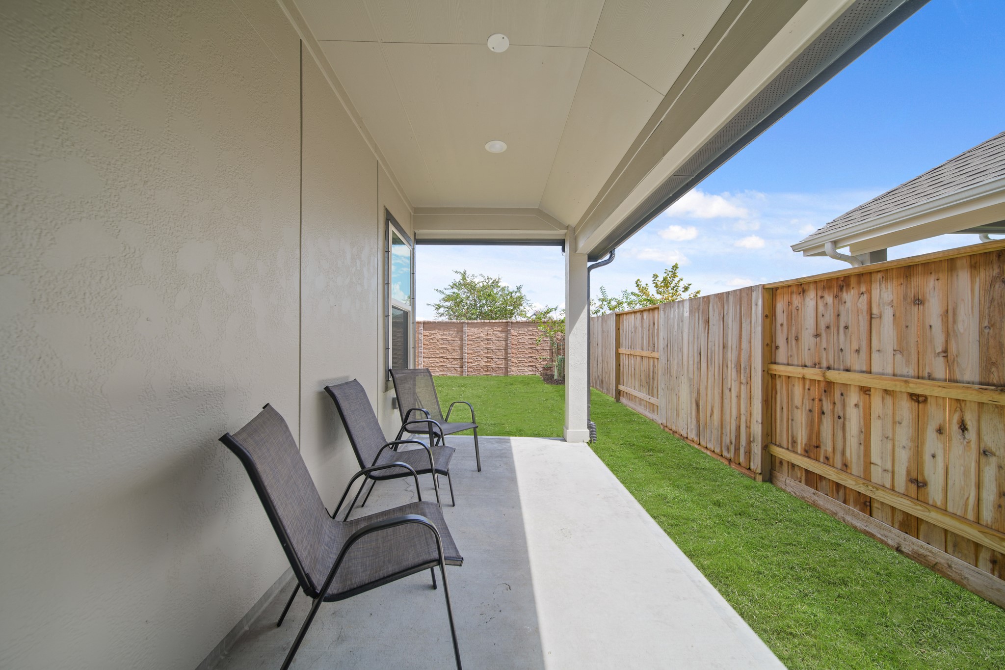 10111 Crescendo Way Manvel, TX 77578 - Photo 23 of 25 a view of a patio with table and chairs with wooden fence