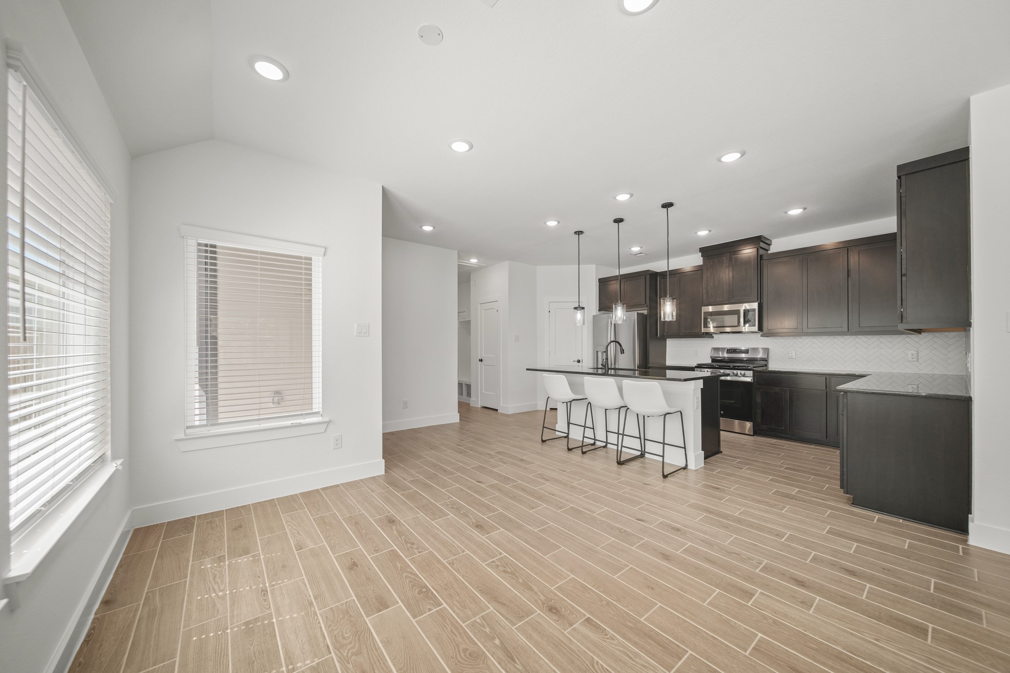 10111 Crescendo Way Manvel, TX 77578 - Photo 8 of 25 a view of kitchen with kitchen island wooden cabinets and stainless steel appliances