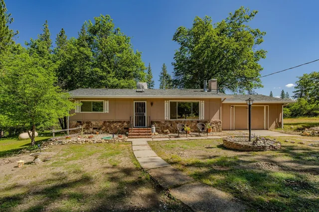 a backyard of a house with garden and patio