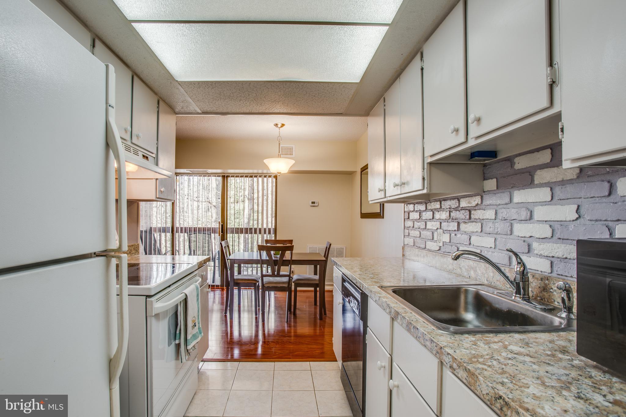 11623 Stoneview Square, Unit 11C Reston, VA 20191 - Photo 2 of 28 Kitchen opens up to dining area