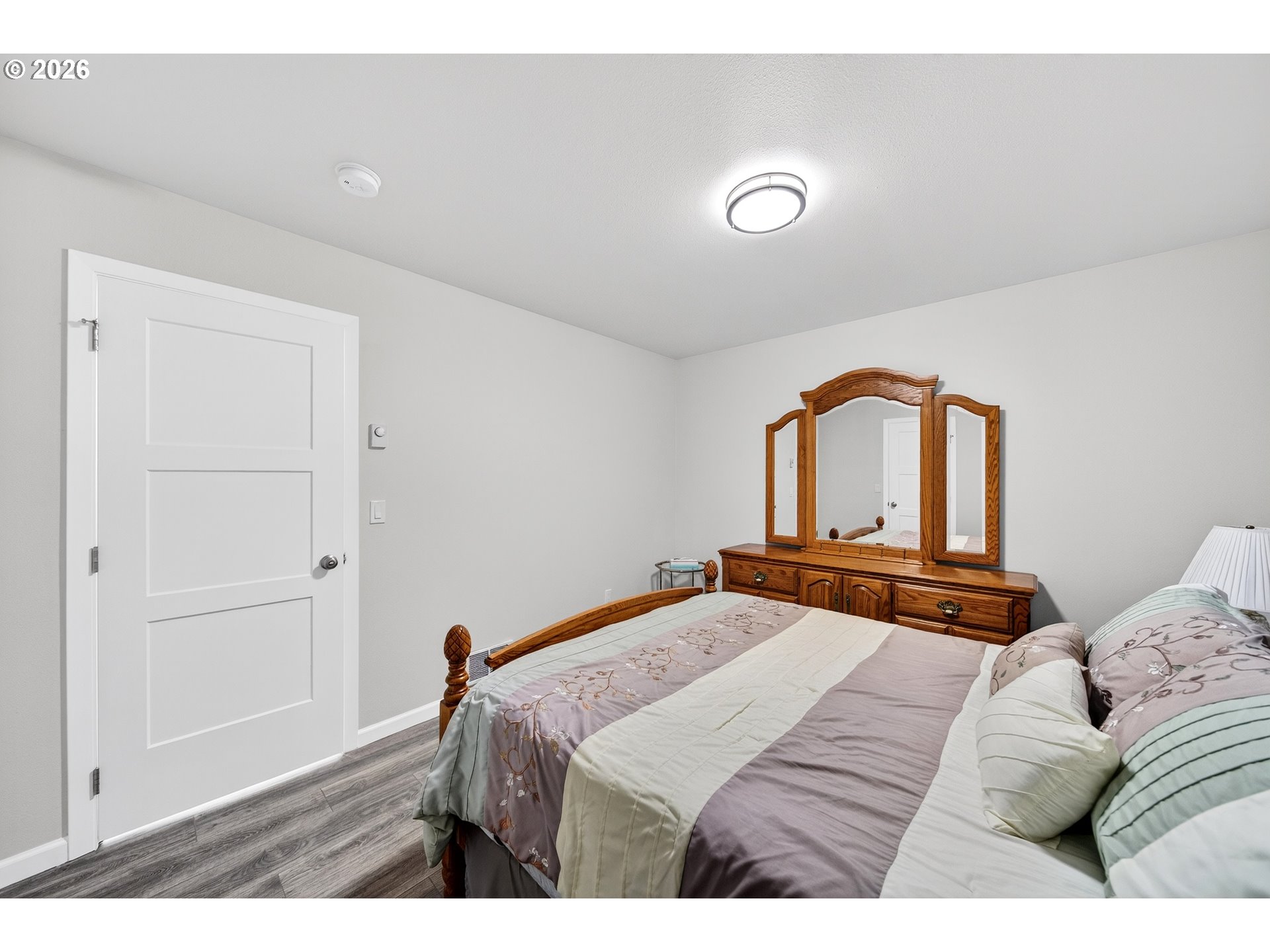 829 Jacobson Way Lakeside, OR 97449 - Photo 15 of 39 a bedroom with a bed and dresser