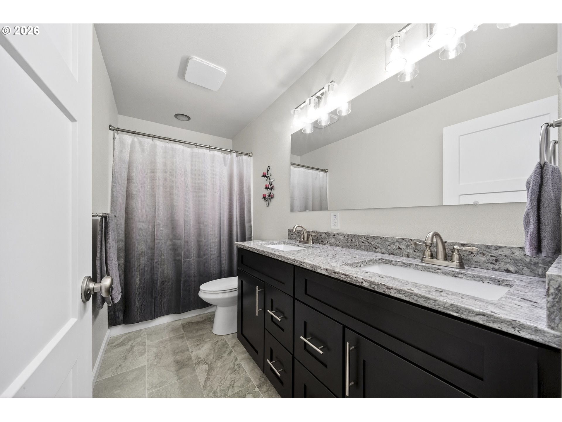 829 Jacobson Way Lakeside, OR 97449 - Photo 17 of 39 a bathroom with a granite countertop sink toilet and a mirror