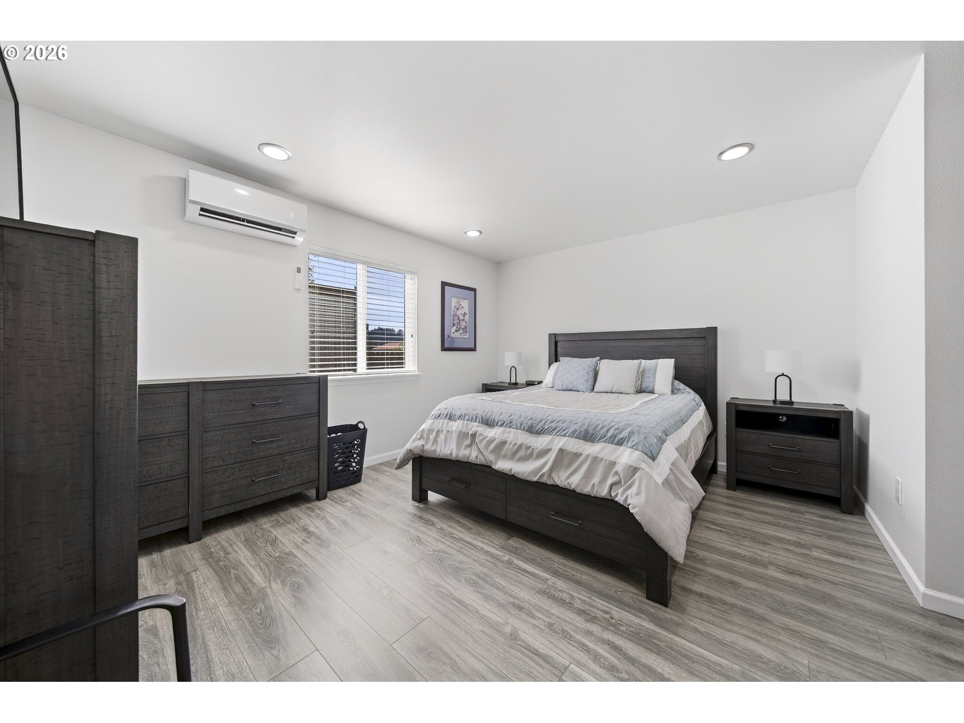 829 Jacobson Way Lakeside, OR 97449 - Photo 18 of 39 a bedroom with a bed cabinets and wooden floor