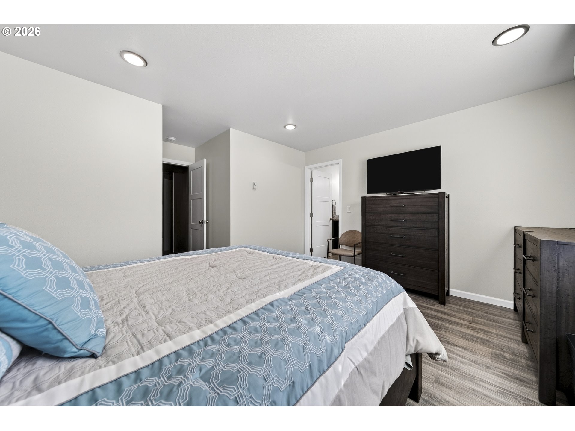 829 Jacobson Way Lakeside, OR 97449 - Photo 19 of 39 a bedroom with a bed and a flat screen tv