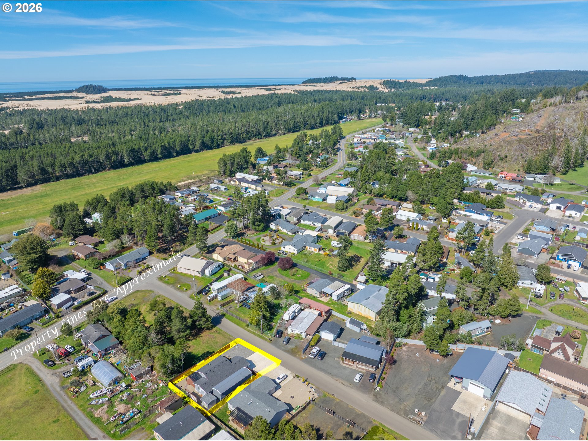 829 Jacobson Way Lakeside, OR 97449 - Photo 2 of 39 an aerial view of a city with lots of residential buildings ocean and mountain view in back
