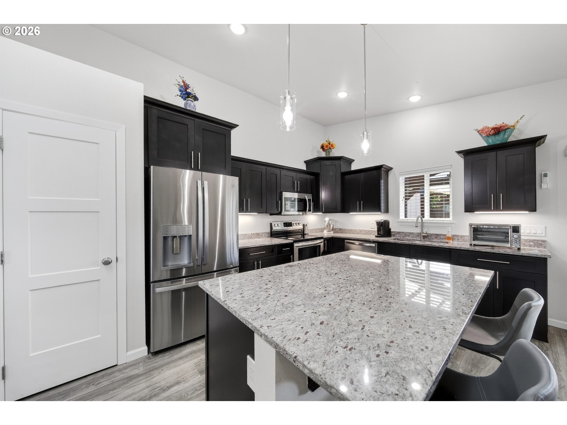 829 Jacobson Way Lakeside, OR 97449 - Photo 6 of 39 a kitchen with stainless steel appliances granite countertop a sink refrigerator and cabinets