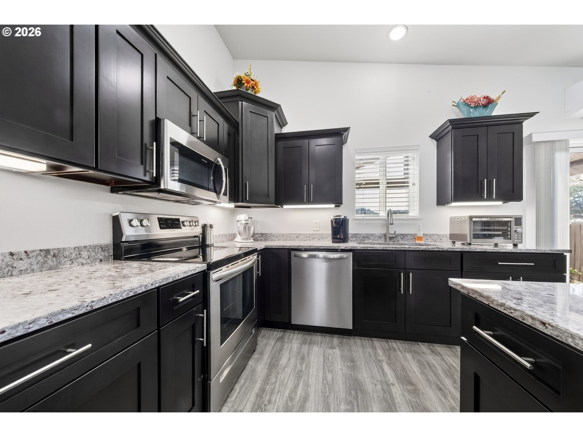 829 Jacobson Way Lakeside, OR 97449 - Photo 7 of 39 a kitchen with stainless steel appliances granite countertop a sink stove and microwave