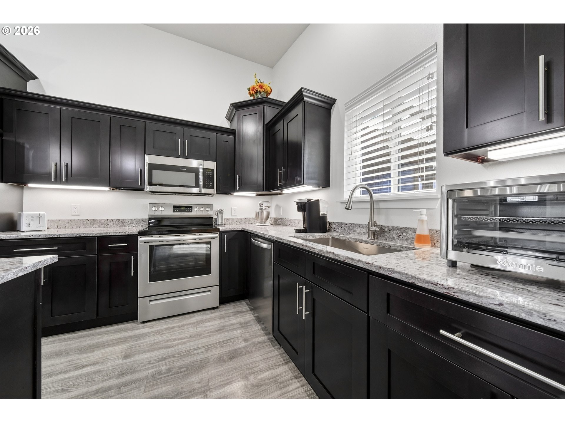 829 Jacobson Way Lakeside, OR 97449 - Photo 8 of 39 a kitchen with stainless steel appliances kitchen island granite countertop a sink stove and refrigerator