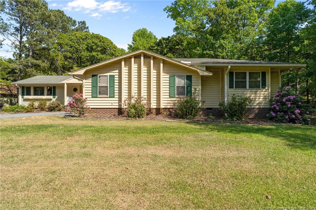 a front view of house with yard and green space