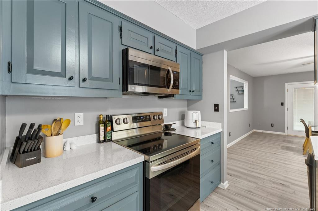 129 Overlook Road Cameron, NC 28326 - Photo 23 of 44 a kitchen with stainless steel appliances a stove microwave and sink