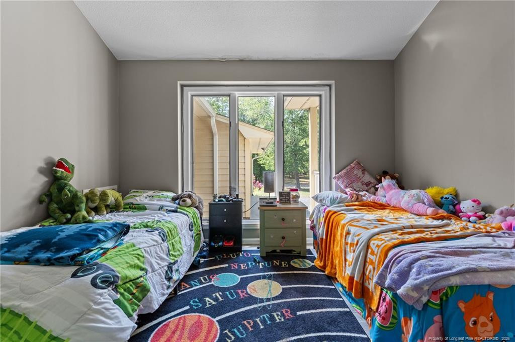 129 Overlook Road Cameron, NC 28326 - Photo 24 of 44 a bed sitting in a bedroom next to a window