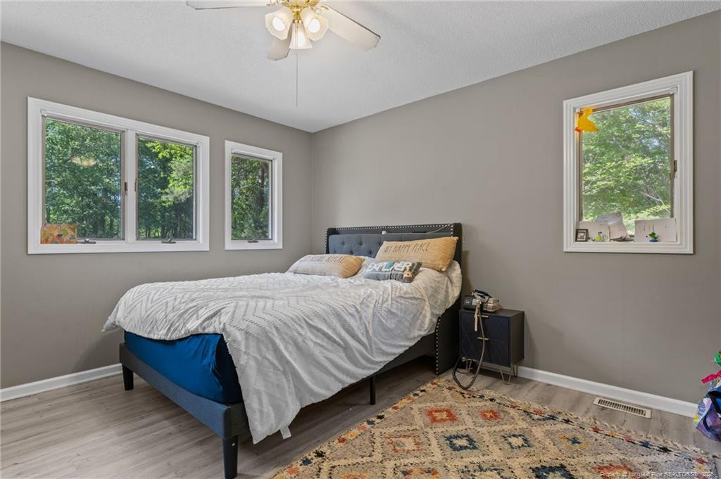 129 Overlook Road Cameron, NC 28326 - Photo 27 of 44 a bed sitting in a bedroom next to a window