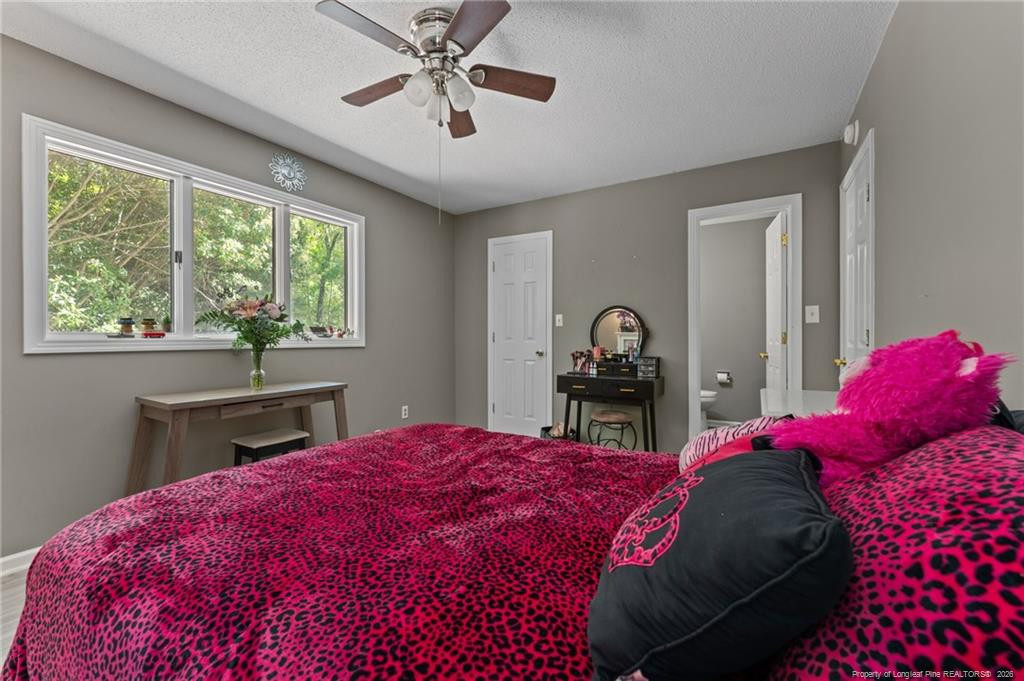 129 Overlook Road Cameron, NC 28326 - Photo 37 of 44 a bedroom with a bed and a chandelier