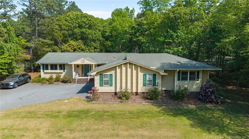 129 Overlook Road Cameron, NC 28326 - Photo 4 of 44 a front view of a house with a yard