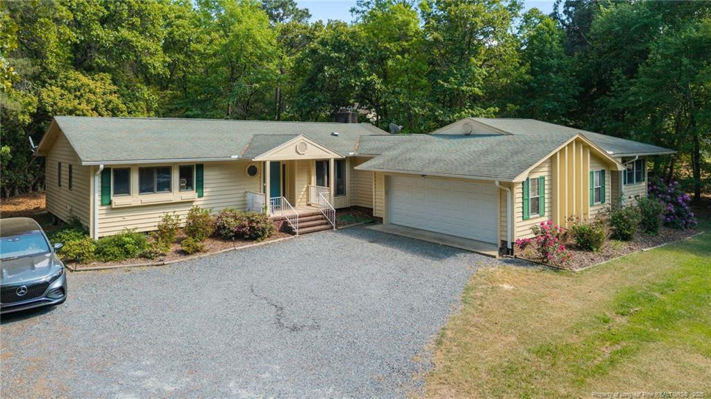 129 Overlook Road Cameron, NC 28326 - Photo 5 of 44 a view of a house with a yard and garage