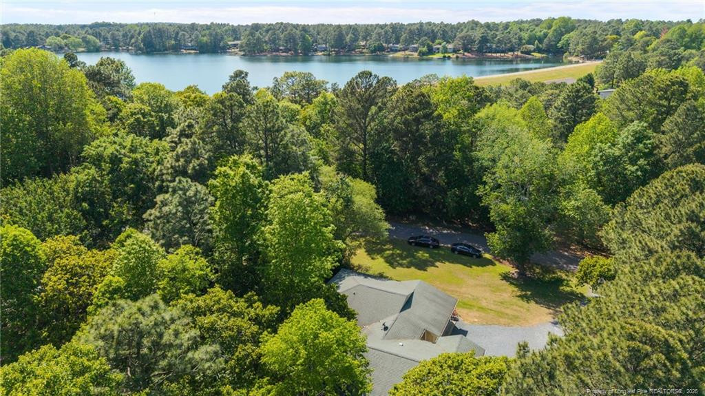129 Overlook Road Cameron, NC 28326 - Photo 10 of 44 an aerial view of lake with residential house with outdoor space and trees around