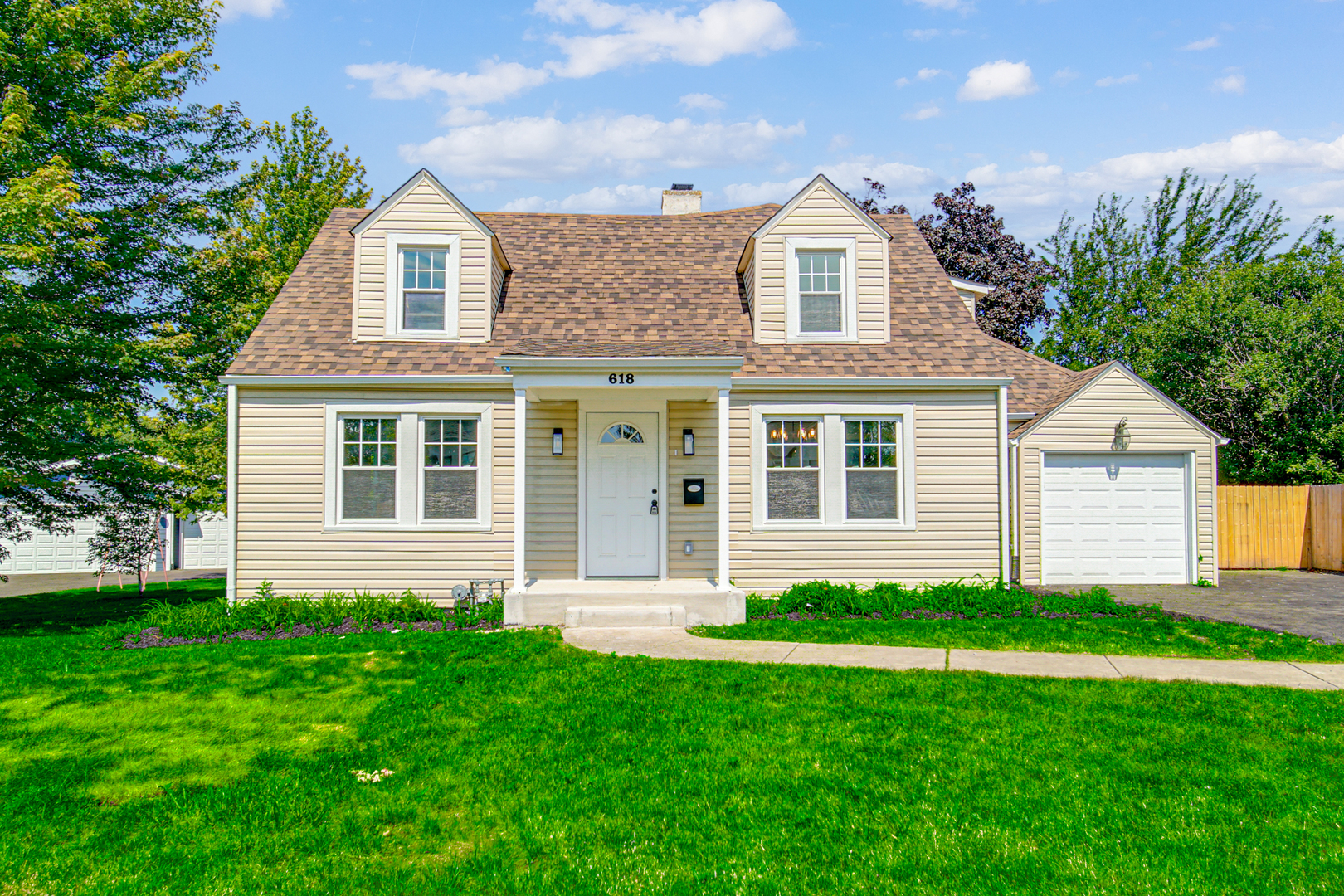 618 Revere Road Glenview, IL 60025 - Photo 2 of 22 a front view of a house with a garden and yard
