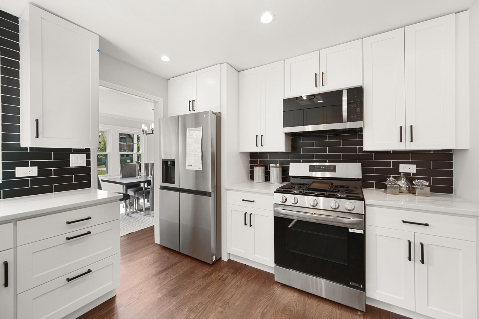 618 Revere Road Glenview, IL 60025 - Photo 6 of 22 a kitchen with a refrigerator stove and white cabinets