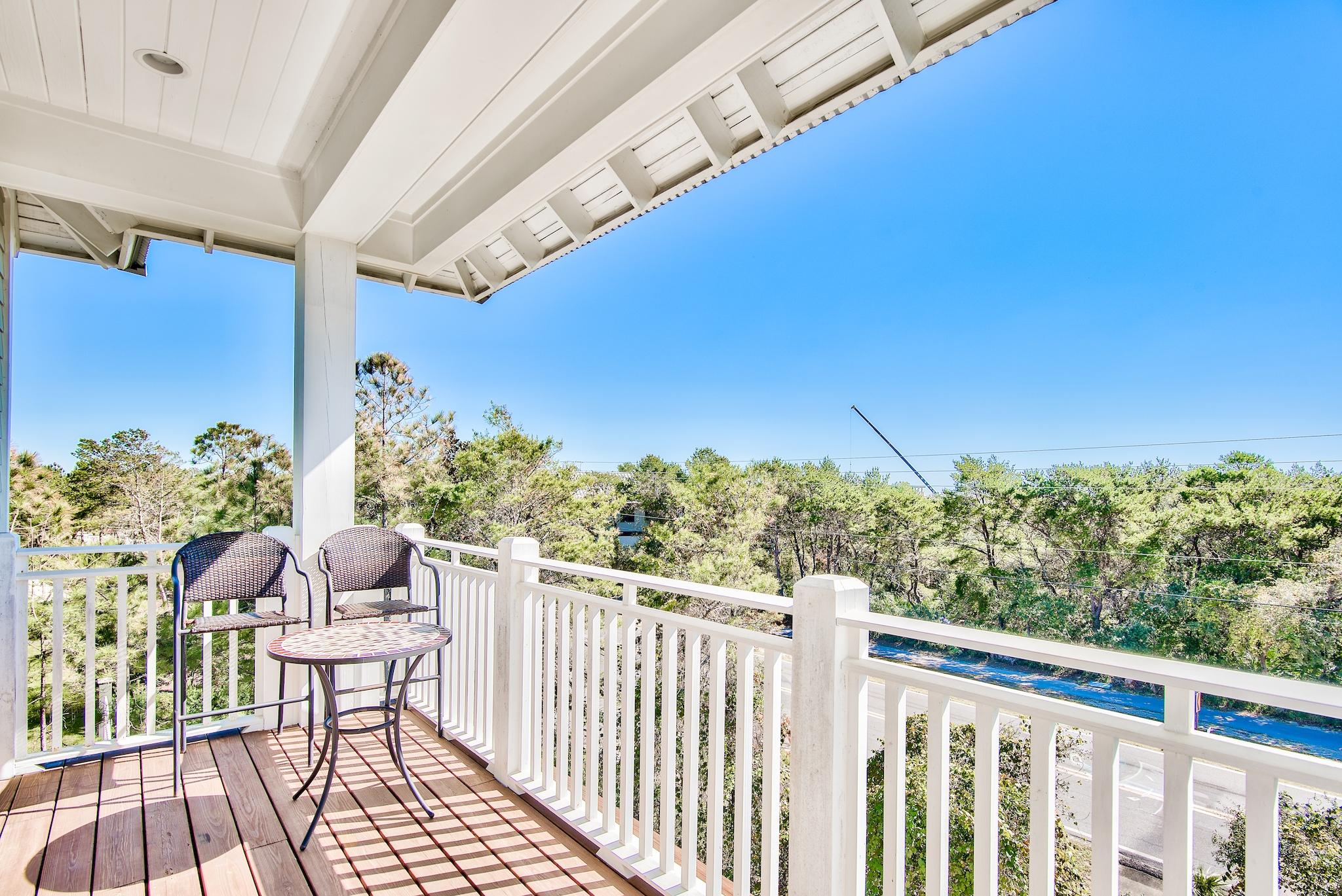 165 Sand Oaks Circle Santa Rosa Beach, FL 32459 - Photo 27 of 54 a view of a balcony with chair and wooden floor